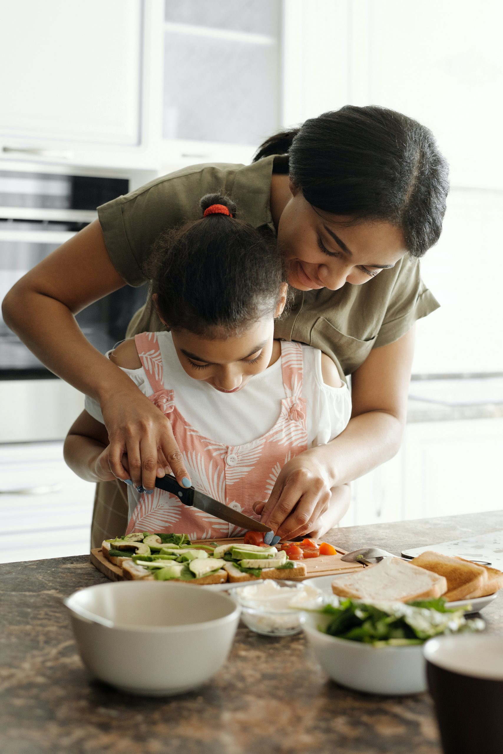 pexels-august-de-richelieu-4259703 mother and daughter cutting vegetables in white kitchen